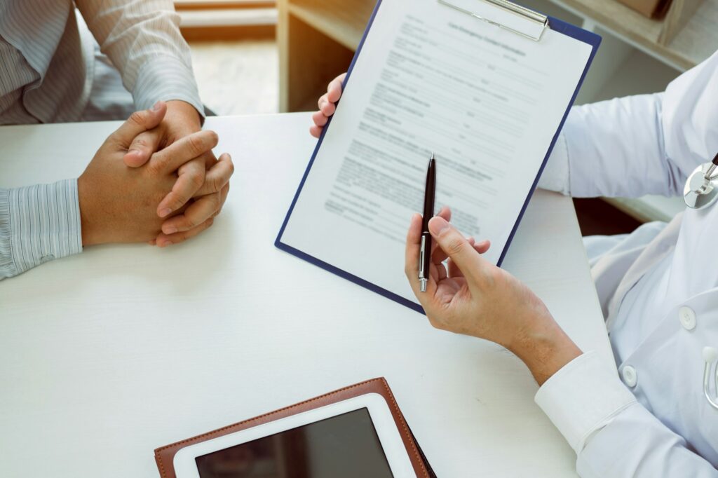 Confident female doctor reviews patient intake forms