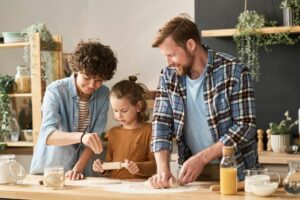 Parenting Strategies: Parents teaching child to bake pie